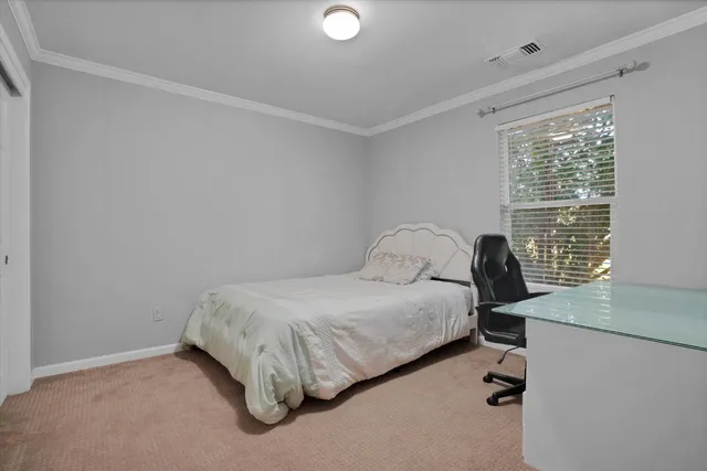 a bedroom with a bed and window