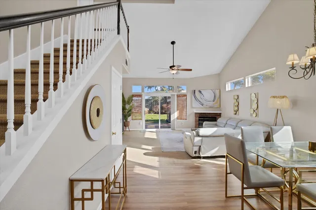 a living room with fireplace furniture and a large window