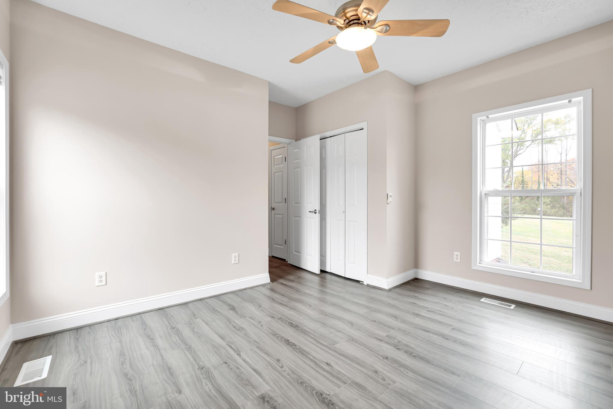 10717 Mt Sharon Road Orange, VA 22960 - Photo 16 of 35 an empty room with wooden floor fan and windows