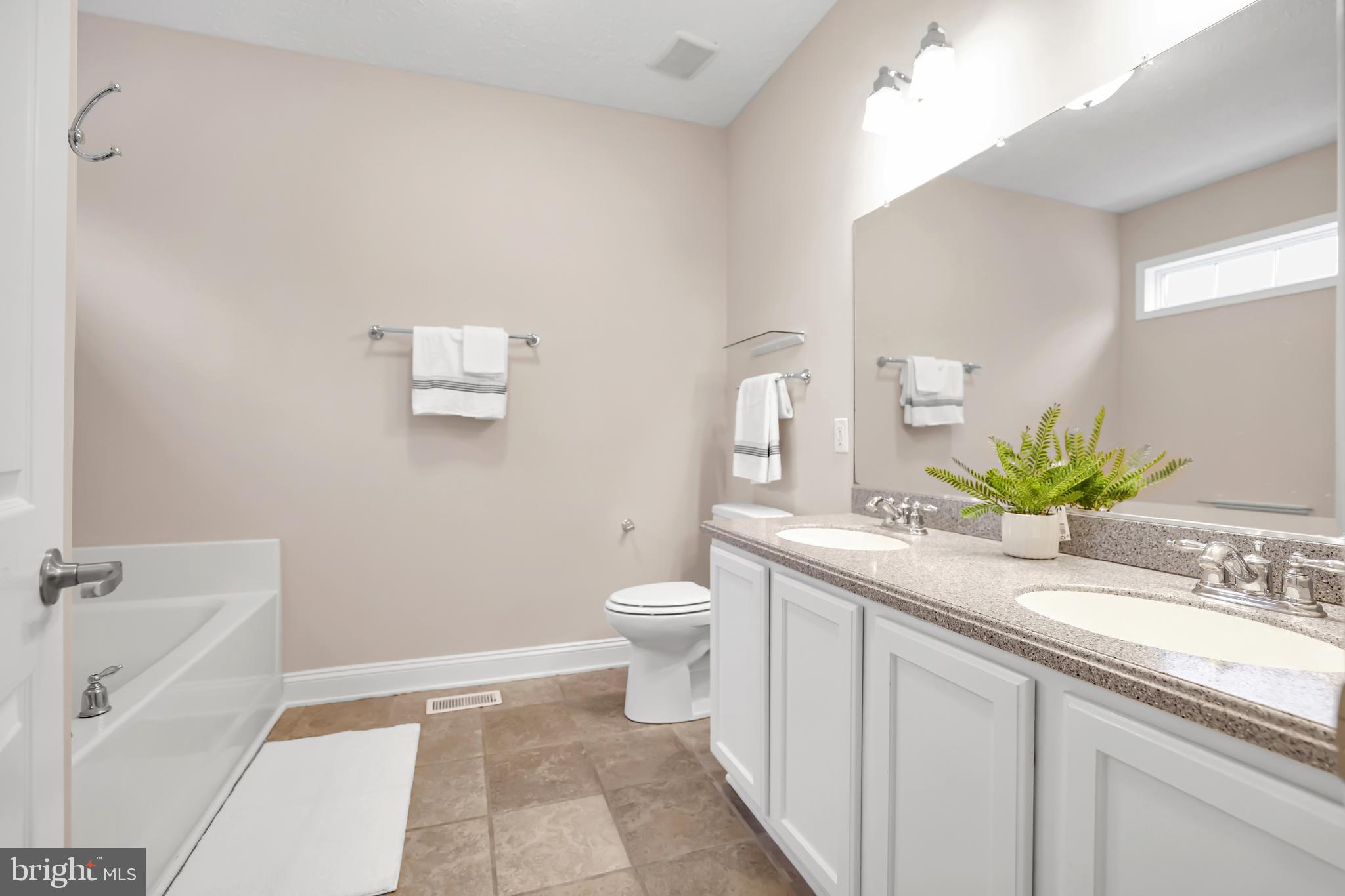 10717 Mt Sharon Road Orange, VA 22960 - Photo 22 of 35 a bathroom with a granite countertop sink a toilet and a bathtub