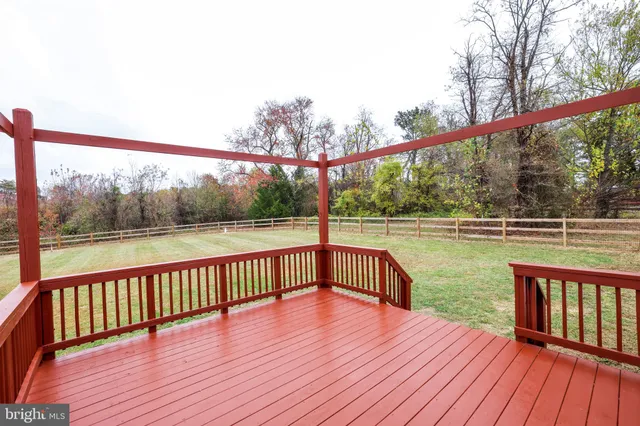 a view of a wooden deck with a yard