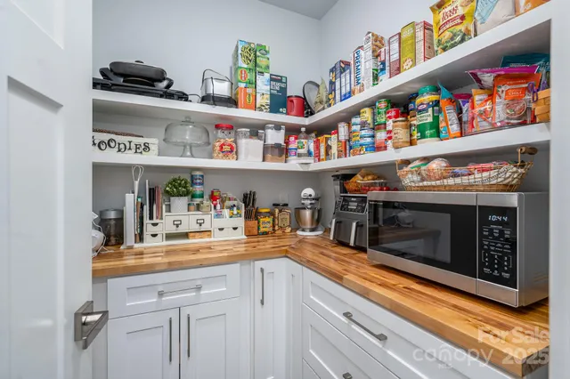 a kitchen with stainless steel appliances granite countertop a sink and a wooden floor