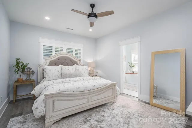 a spacious bedroom with a bed and a chandelier