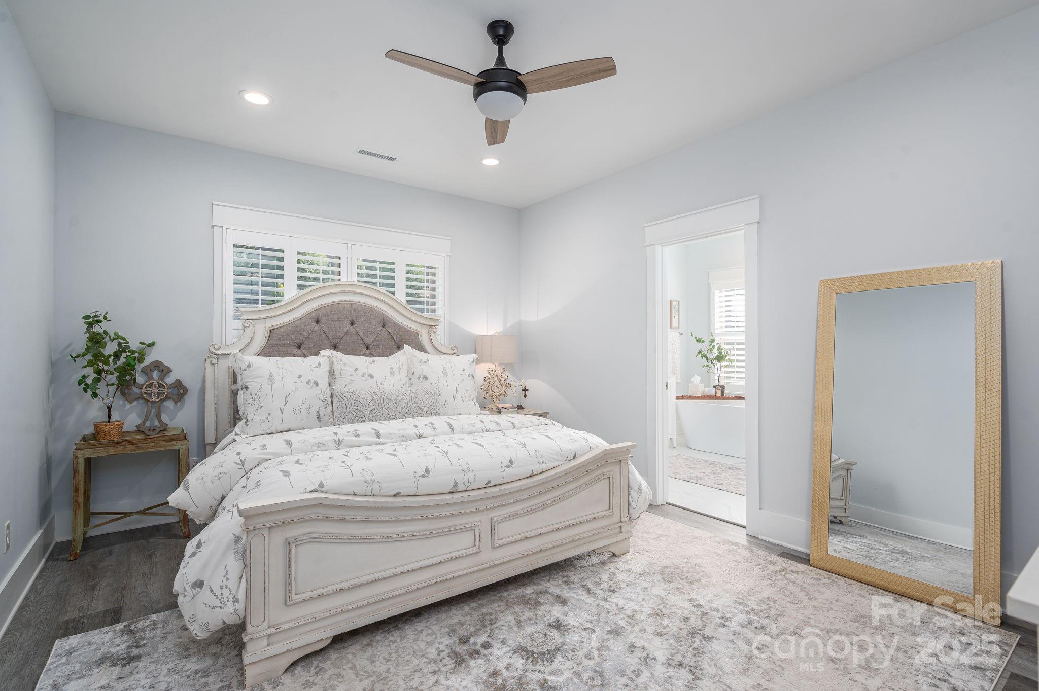 4290 Holly Circle Northeast Conover, NC 28613 - Photo 20 of 48 a spacious bedroom with a bed and a chandelier