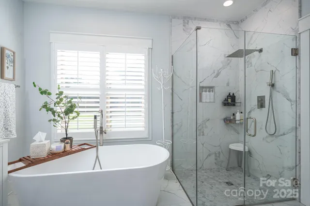 a white bath tub sitting next to a blue shower