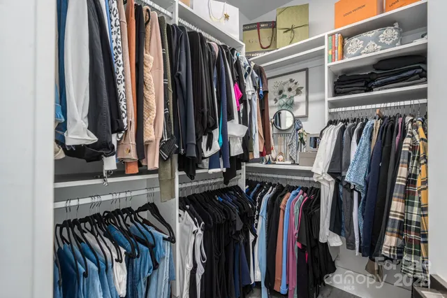 a view of walk in closet with clothes