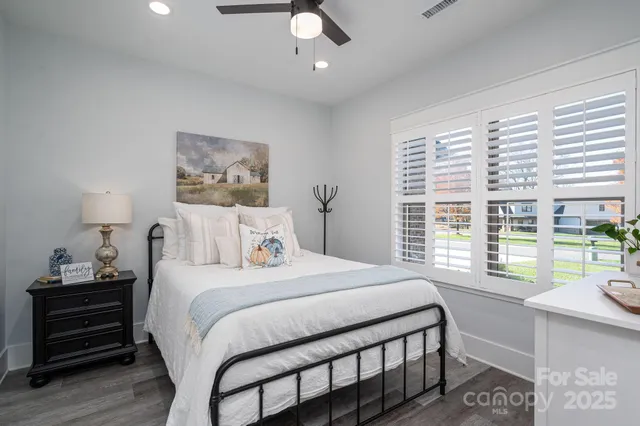 a bedroom with a bed and a large window