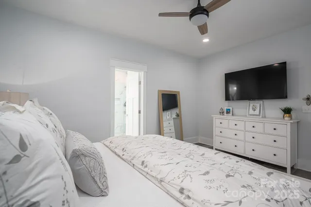 a bedroom with a bed and a flat screen tv