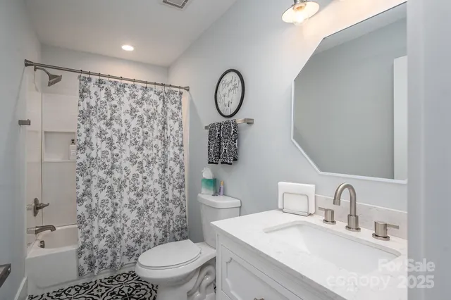 a bathroom with a toilet a sink and a shower