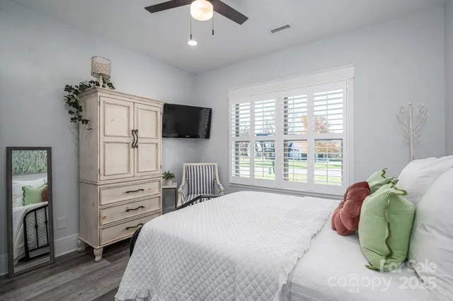 a bedroom with a bed and a television