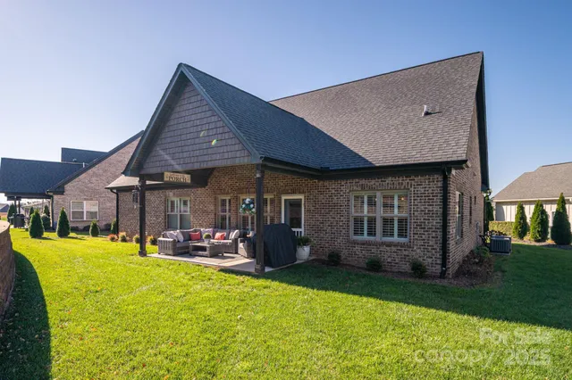 a front view of house with a garden and patio