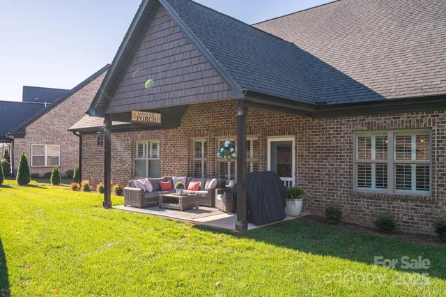 a view of a house with a yard patio and fire pit