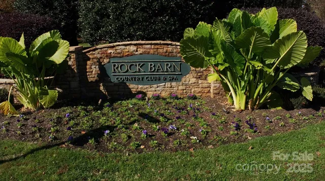 a sign that is sitting in front of flowers