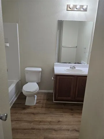 a bathroom with a sink a toilet and mirror