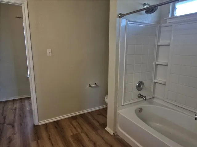a bathroom with a tub and shower