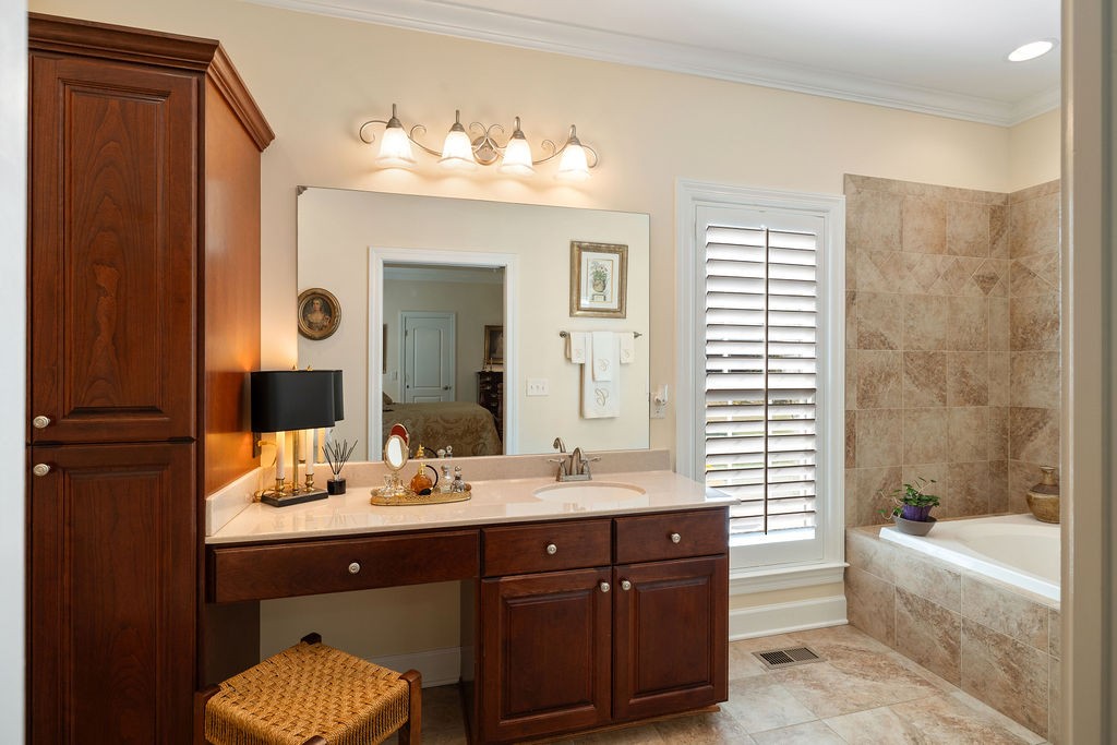114 Hummingbird Lane Lawrenceburg, TN 38464 - Photo 18 of 38 a bathroom with a tub double vanity sink and mirror
