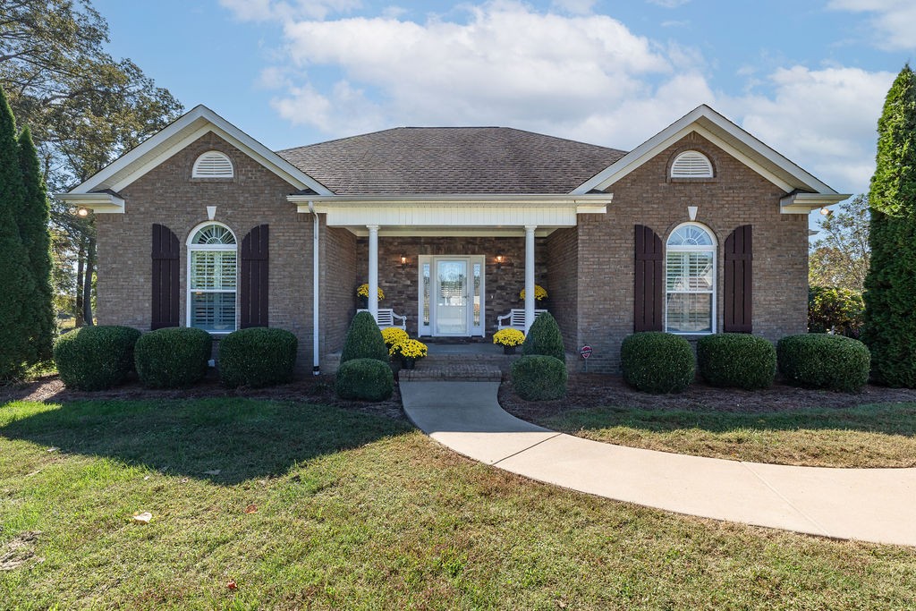 114 Hummingbird Lane Lawrenceburg, TN 38464 - Photo 2 of 38 a front view of a house with a yard and garage