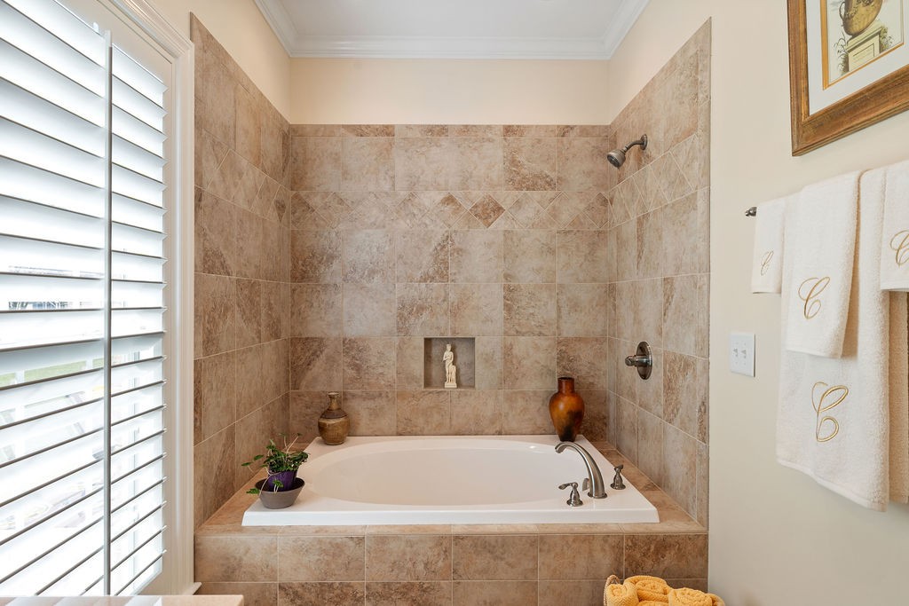 114 Hummingbird Lane Lawrenceburg, TN 38464 - Photo 21 of 38 a bath tub sitting in a bathroom next to a window