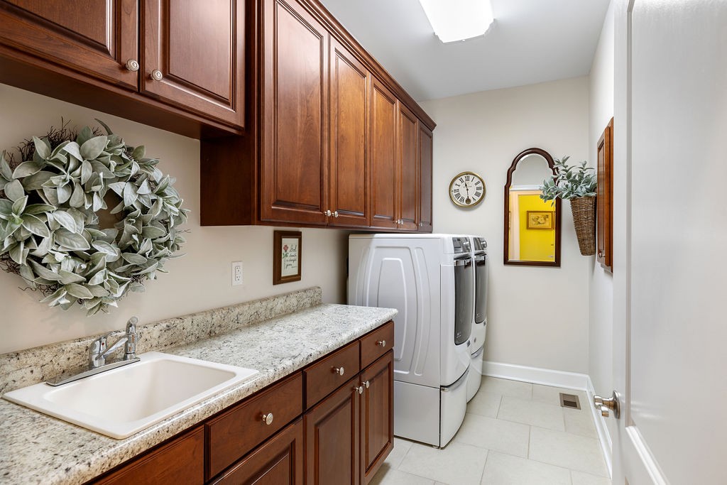 114 Hummingbird Lane Lawrenceburg, TN 38464 - Photo 27 of 38 a bathroom with a granite countertop sink and a mirror