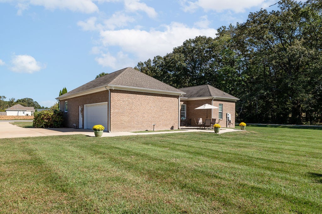 114 Hummingbird Lane Lawrenceburg, TN 38464 - Photo 31 of 38 a front view of a house with a yard and garage