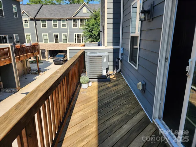 a view of balcony with wooden floor and fence