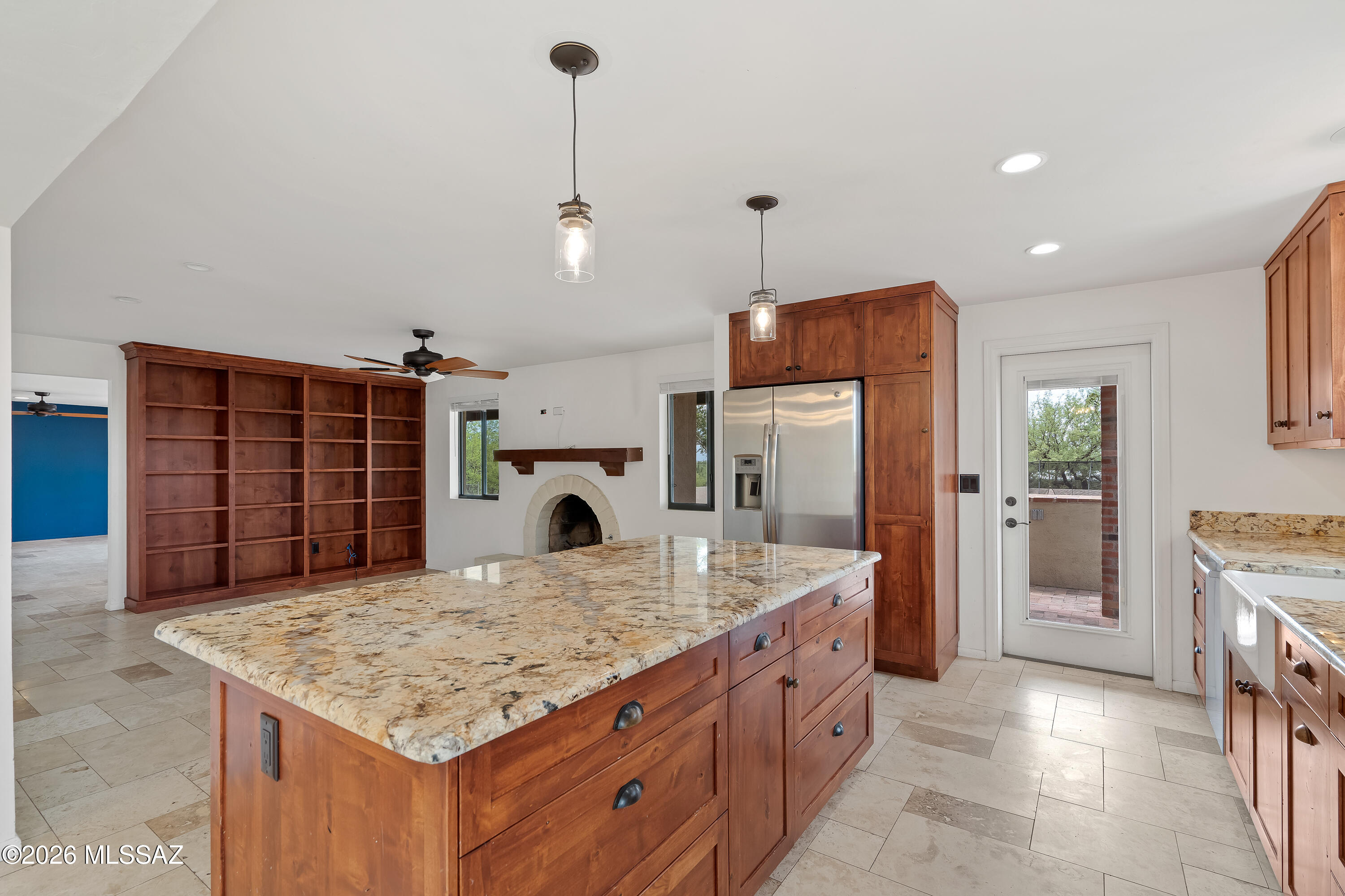 9420 East Ravine Trail Tucson, AZ 85749 - Photo 14 of 39 a kitchen with kitchen island a counter top space a sink stainless steel appliances and cabinets
