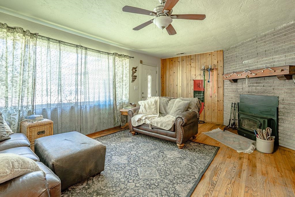 470 Riverside Avenue Chester, CA 96020 - Photo 5 of 25 a bedroom with furniture and a fireplace