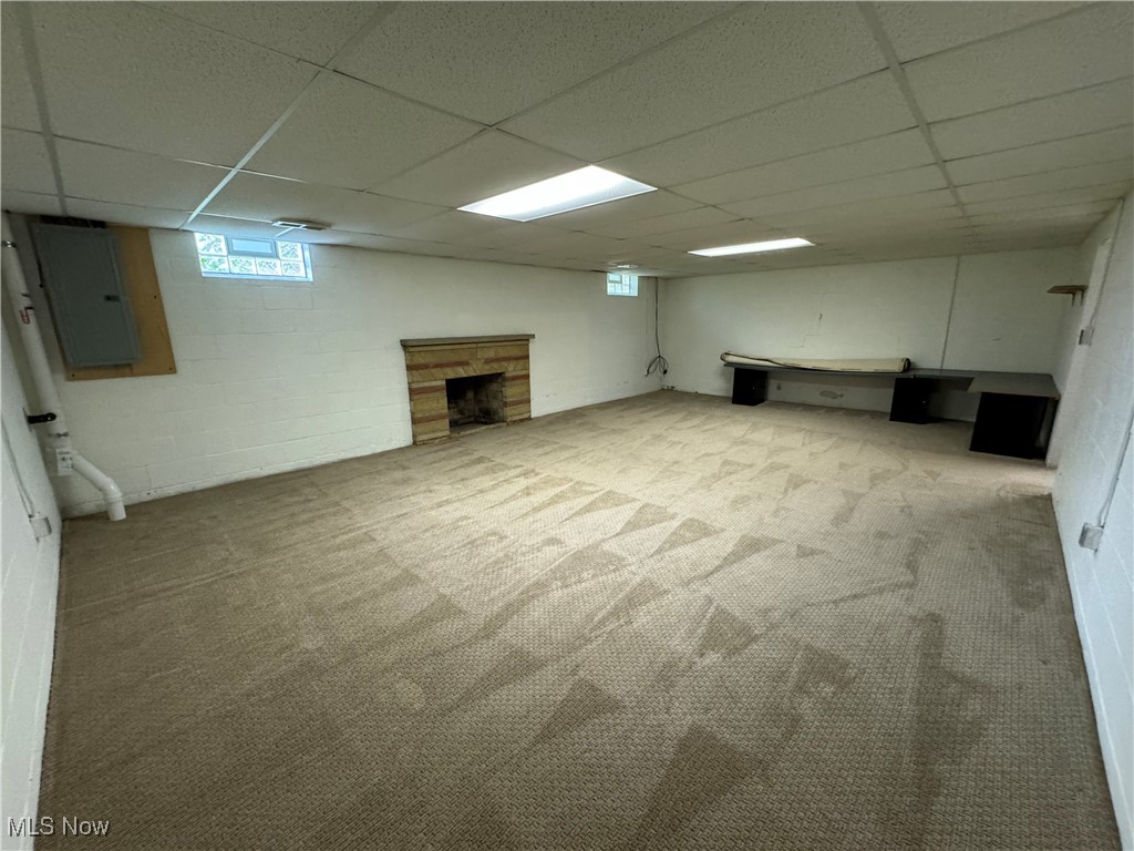 3115 Echo Hills Road Akron, OH 44333 - Photo 20 of 33 Basement featuring a drop ceiling, electric panel, and newer carpet.