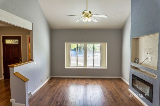 316 Mesquite Avenue Ridgecrest, CA 93555 - Photo 5 of 38 a view of an empty room with a fireplace and wooden floor