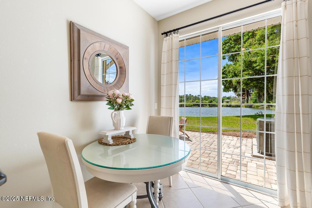 555 Hedgewood Drive St. Augustine, FL 32092 - Photo 14 of 70 a dining room with furniture and a floor to ceiling window