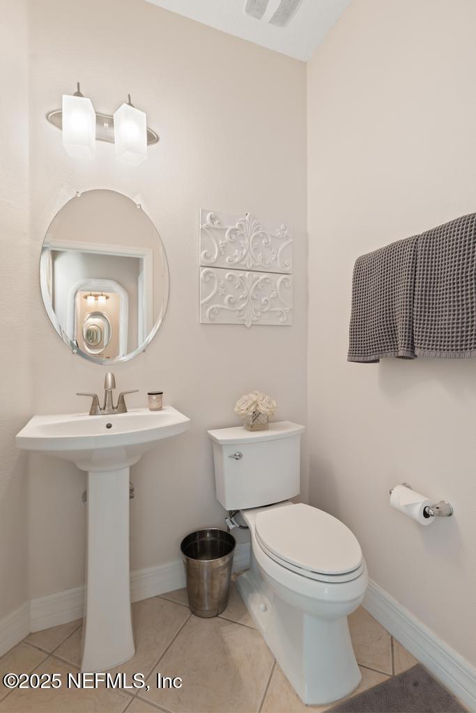555 Hedgewood Drive St. Augustine, FL 32092 - Photo 22 of 70 a bathroom with a sink a toilet and mirror