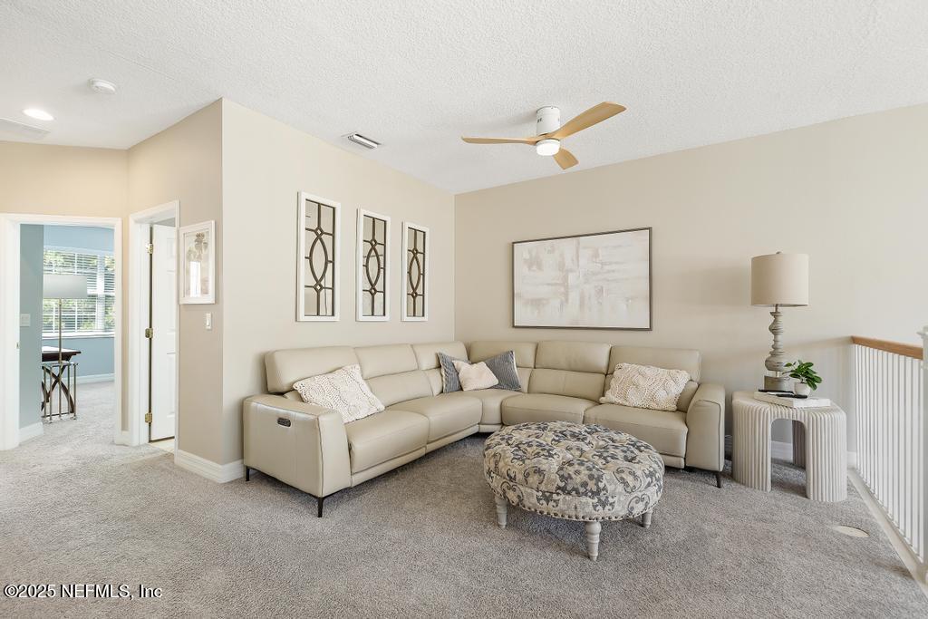 555 Hedgewood Drive St. Augustine, FL 32092 - Photo 24 of 70 a living room with furniture and a painting