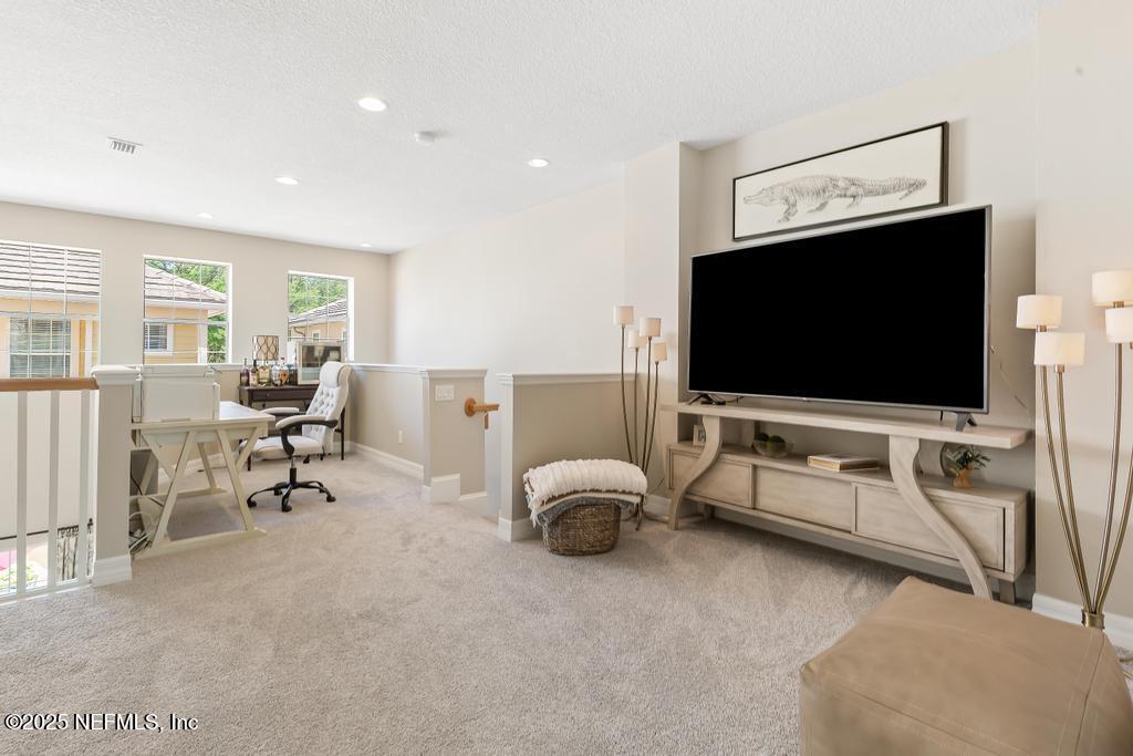 555 Hedgewood Drive St. Augustine, FL 32092 - Photo 26 of 70 a living room with furniture and a flat screen tv