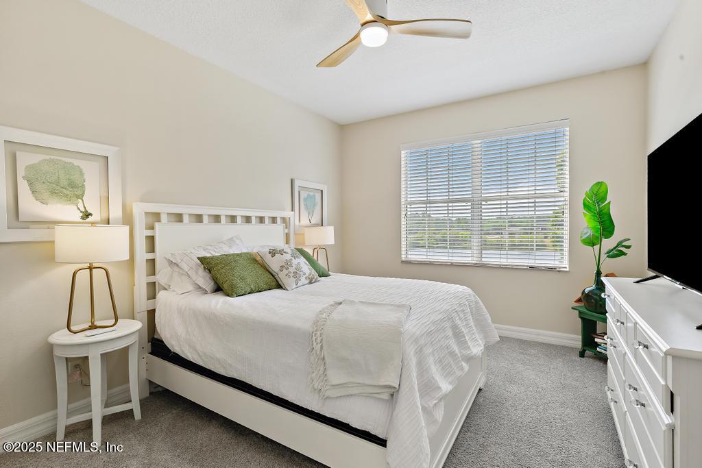 555 Hedgewood Drive St. Augustine, FL 32092 - Photo 29 of 70 a bedroom with a bed and a flat tv screen on dresser