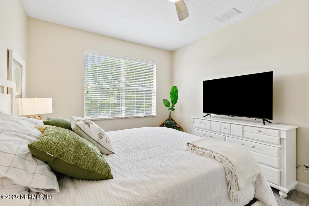 555 Hedgewood Drive St. Augustine, FL 32092 - Photo 30 of 70 a bedroom with a bed and a television
