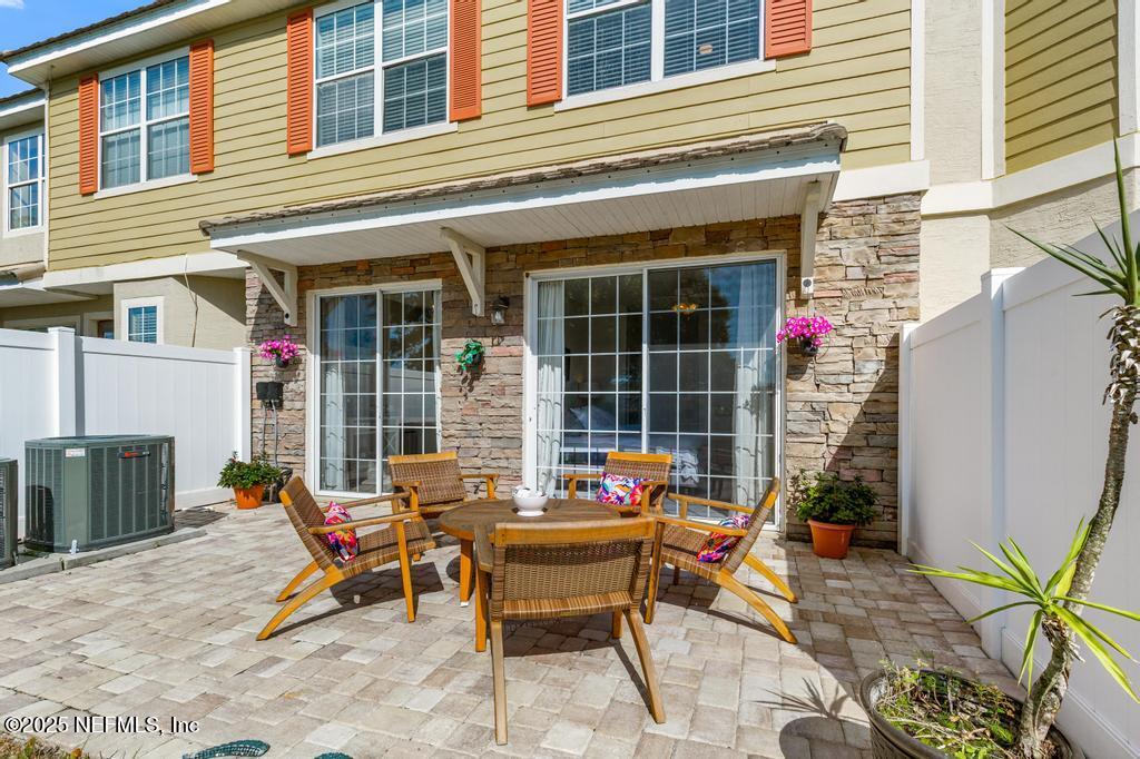 555 Hedgewood Drive St. Augustine, FL 32092 - Photo 35 of 70 a backyard of a house with outdoor seating