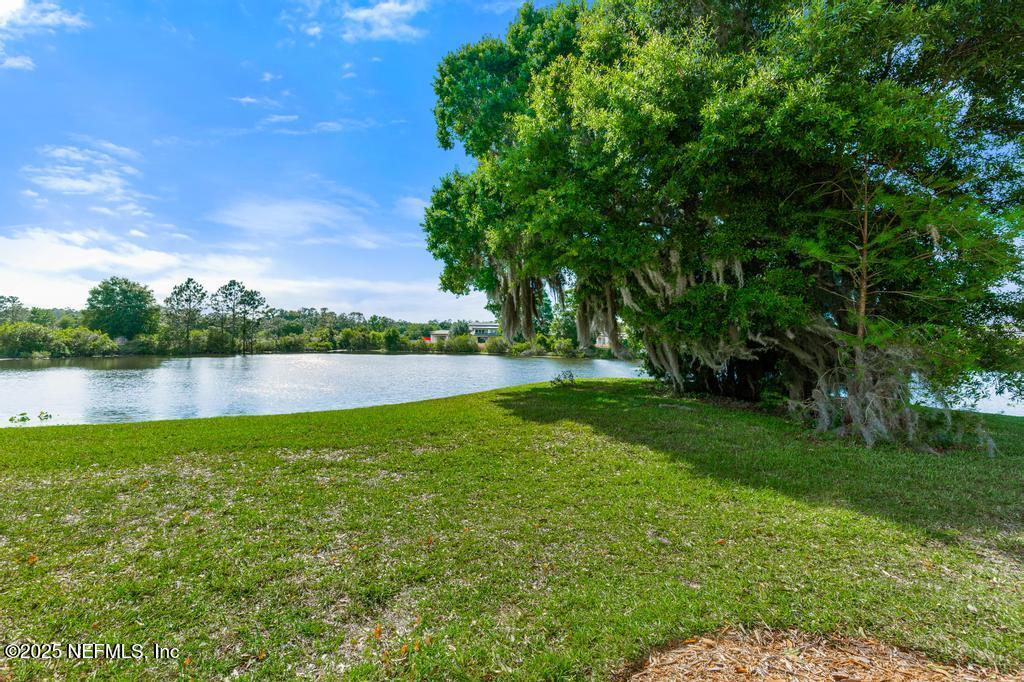 555 Hedgewood Drive St. Augustine, FL 32092 - Photo 36 of 70 a view of a lake with houses in the back