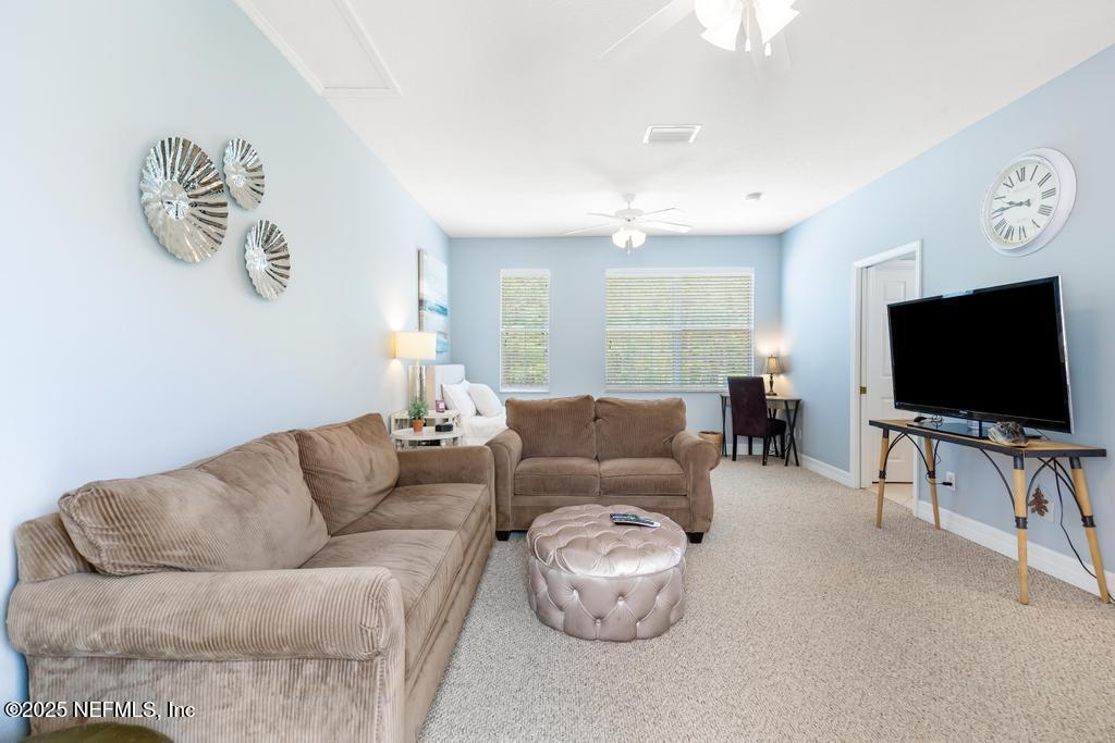 555 Hedgewood Drive St. Augustine, FL 32092 - Photo 41 of 70 a living room with furniture and a flat screen tv