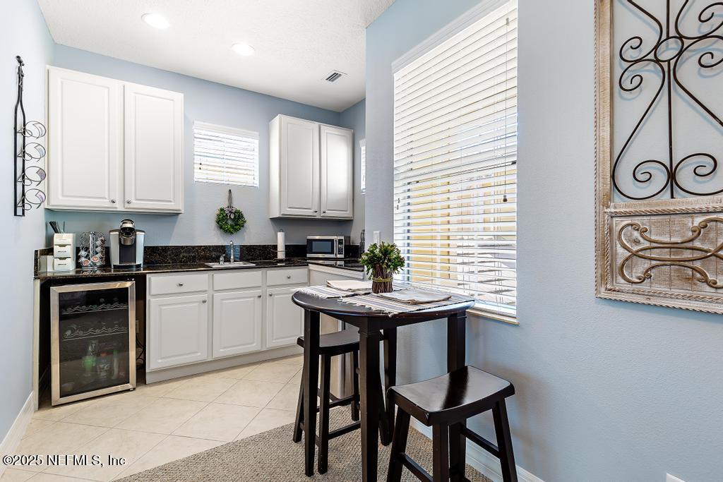 555 Hedgewood Drive St. Augustine, FL 32092 - Photo 42 of 70 a kitchen with stainless steel appliances granite countertop a stove a sink dishwasher and cabinets with wooden floor