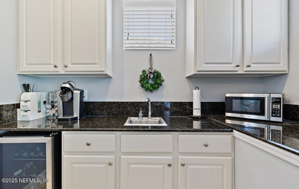 555 Hedgewood Drive St. Augustine, FL 32092 - Photo 44 of 70 a kitchen with white cabinets and appliances