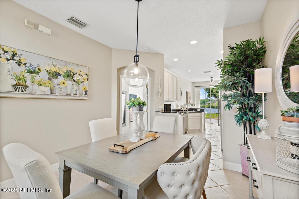 555 Hedgewood Drive St. Augustine, FL 32092 - Photo 9 of 70 a view of a dining room with furniture and chandelier