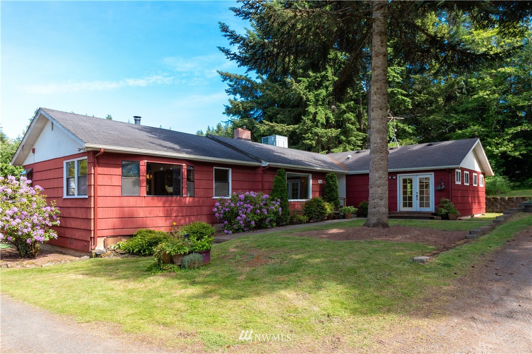 241 Cousins Road Chehalis, WA 98532 - Photo 1 of 27 a front view of a house with a garden and trees