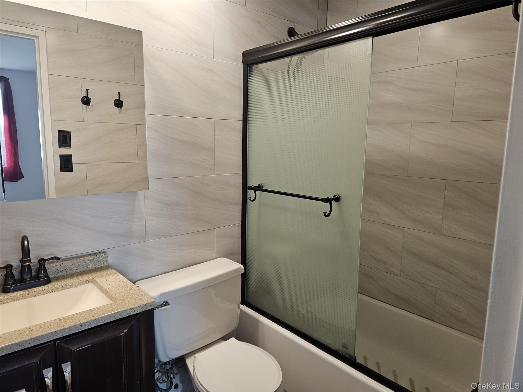 2 Richmond Road, Unit 4F Lido Beach, NY 11561 - Photo 12 of 27 a bathroom with a sink a toilet and shower