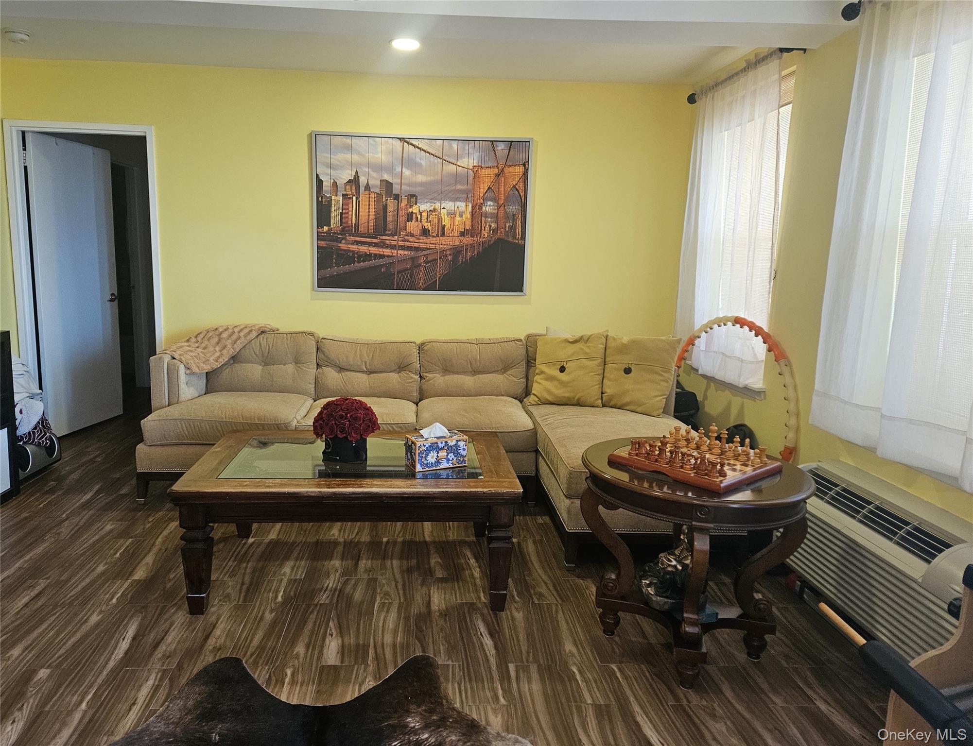 2 Richmond Road, Unit 4F Lido Beach, NY 11561 - Photo 6 of 26 Living area featuring dark porcelain tile finished floors, an AC wall unit, and recessed lighting