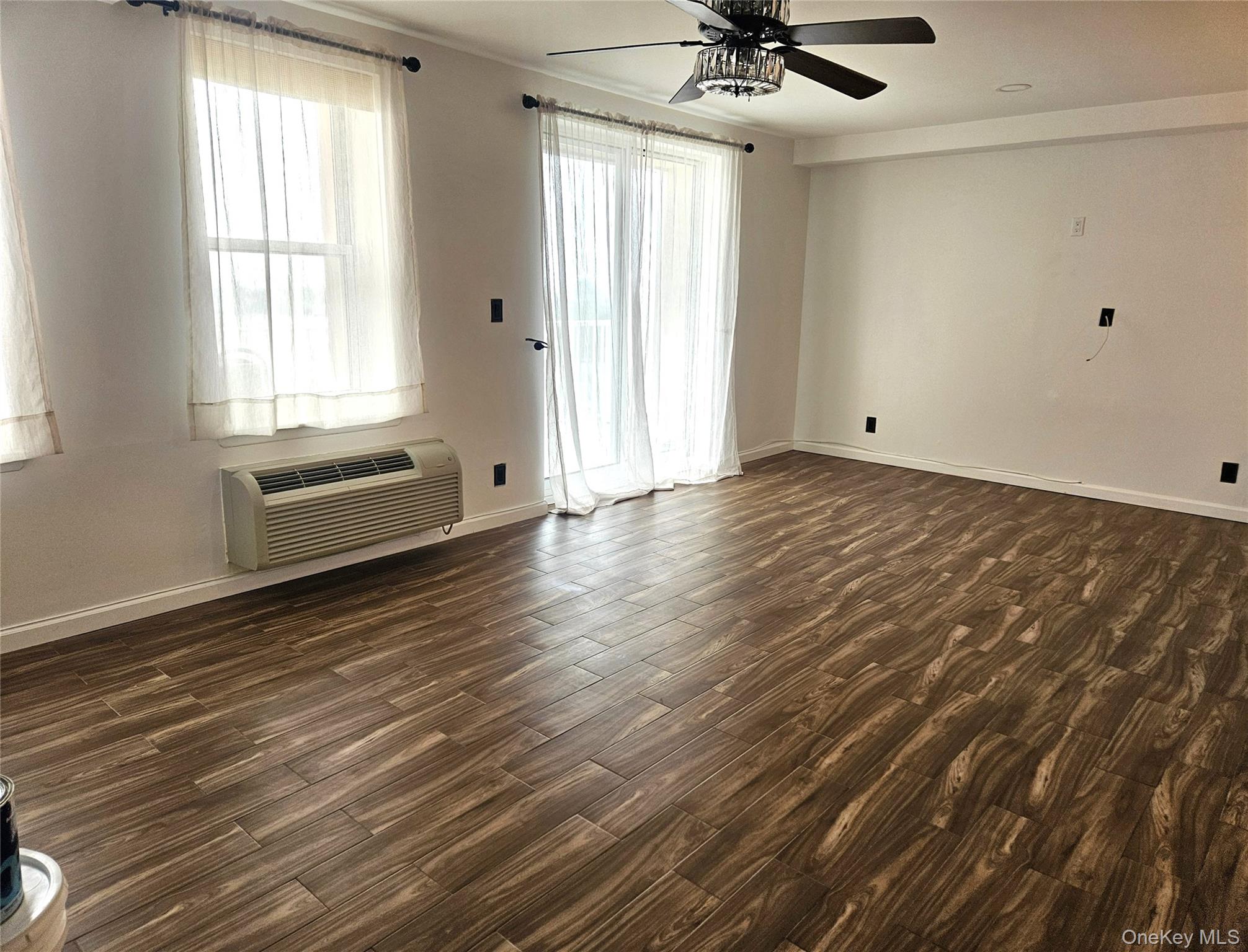 2 Richmond Road, Unit 4F Lido Beach, NY 11561 - Photo 7 of 27 a view of a livingroom with a ceiling fan and window