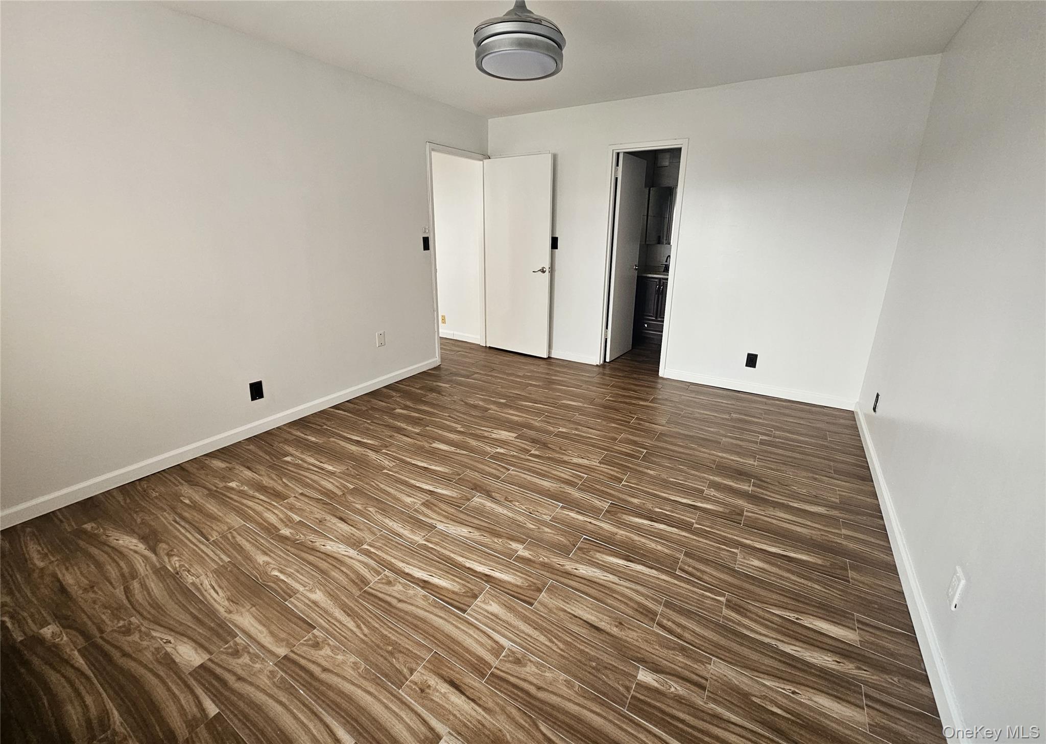 2 Richmond Road, Unit 4F Lido Beach, NY 11561 - Photo 10 of 27 a view of an empty room with wooden floor