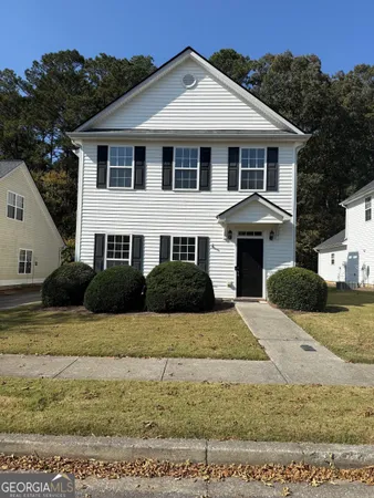 a front view of a house with a yard