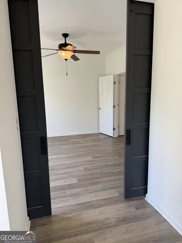a view of empty room with wooden floor