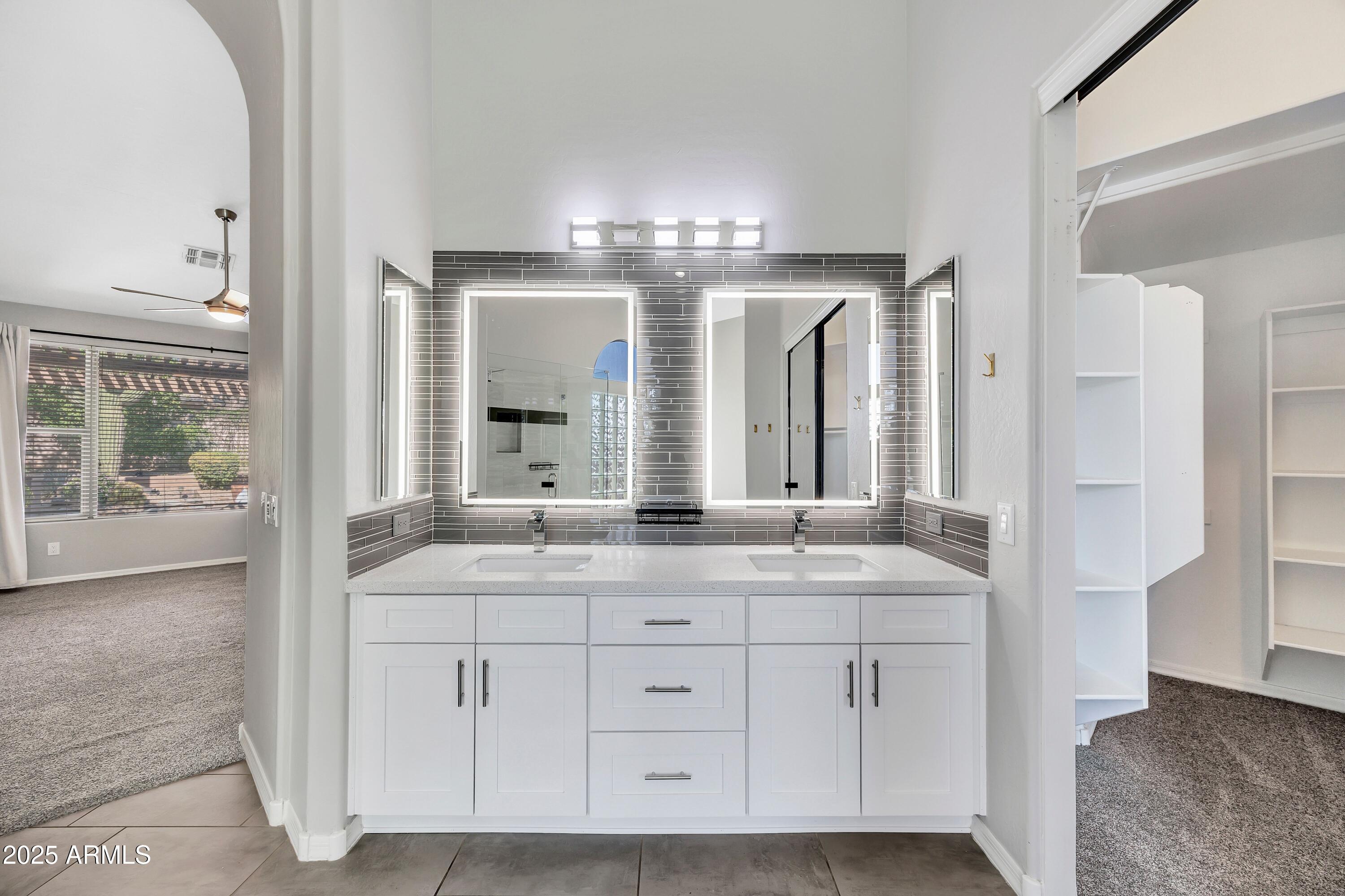 7446 East Glenn Moore Road Scottsdale, AZ 85255 - Photo 12 of 18 a bathroom with double vanity and a mirror