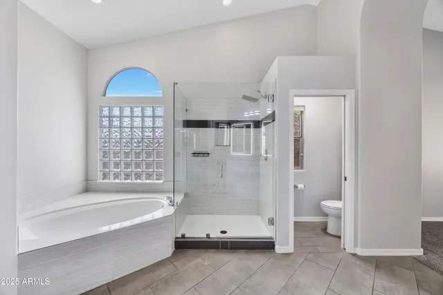 an empty room with a ceiling fan and a window